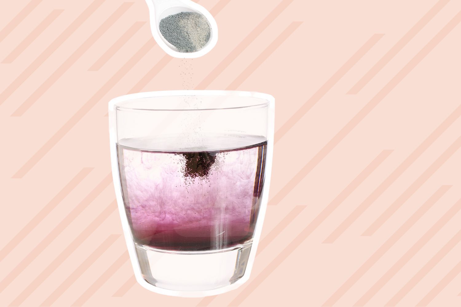Spoonful of powder flavoring above a glass full of water displayed on a pink background