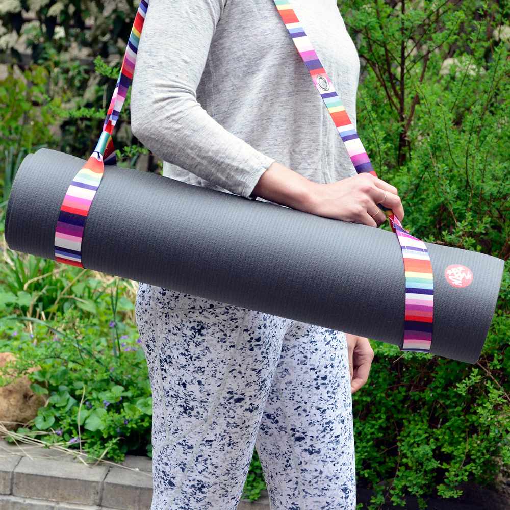Person carrying Manduka PRO Yoga Mat with a yoga mat sling