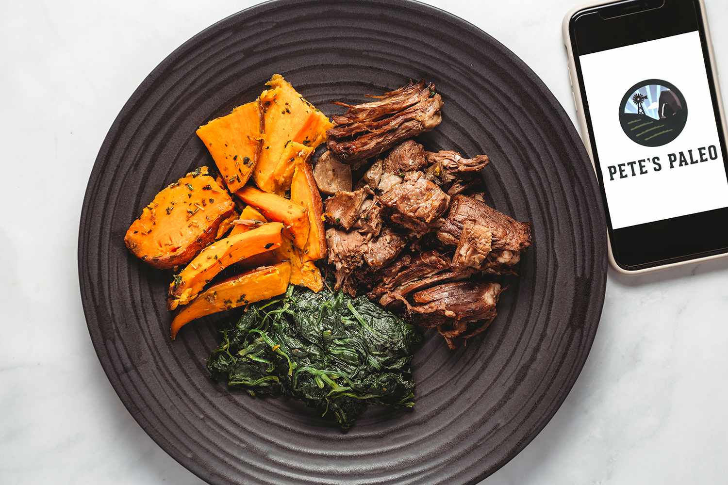beef, sweet potatoes, and spinach on a plate