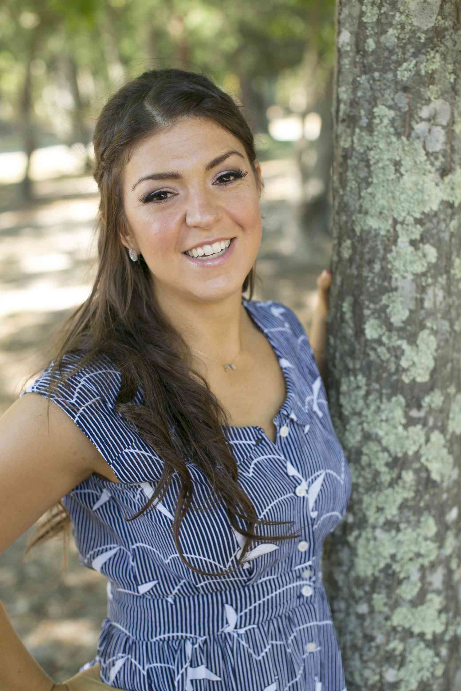 Photo of a girl Shoshana Pritzker standing near a tree.
