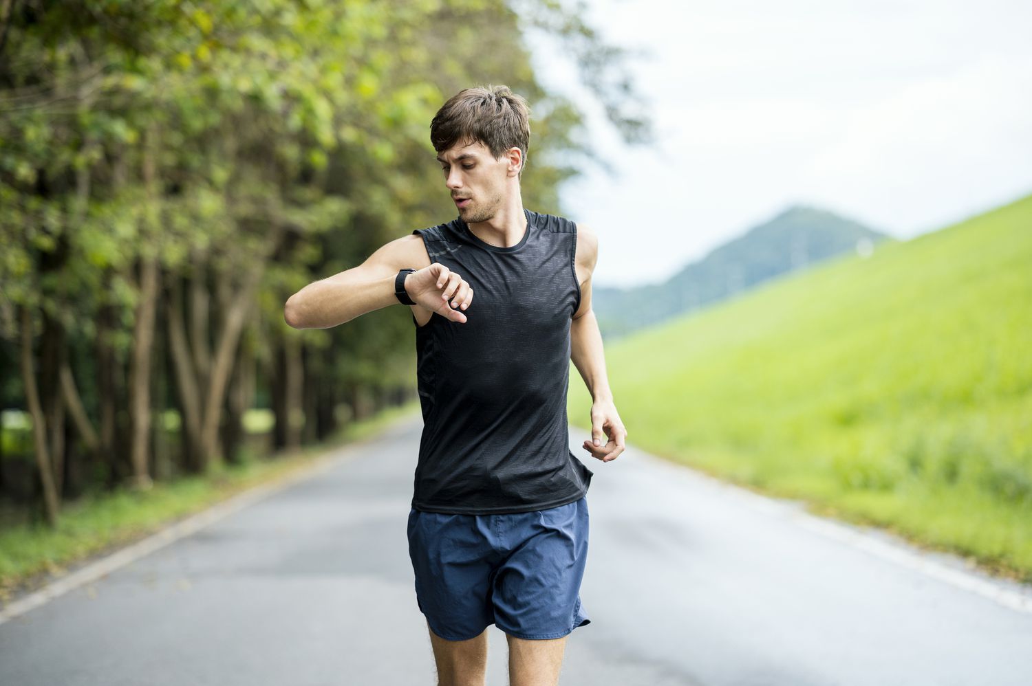 Man checking his fitness watch while running