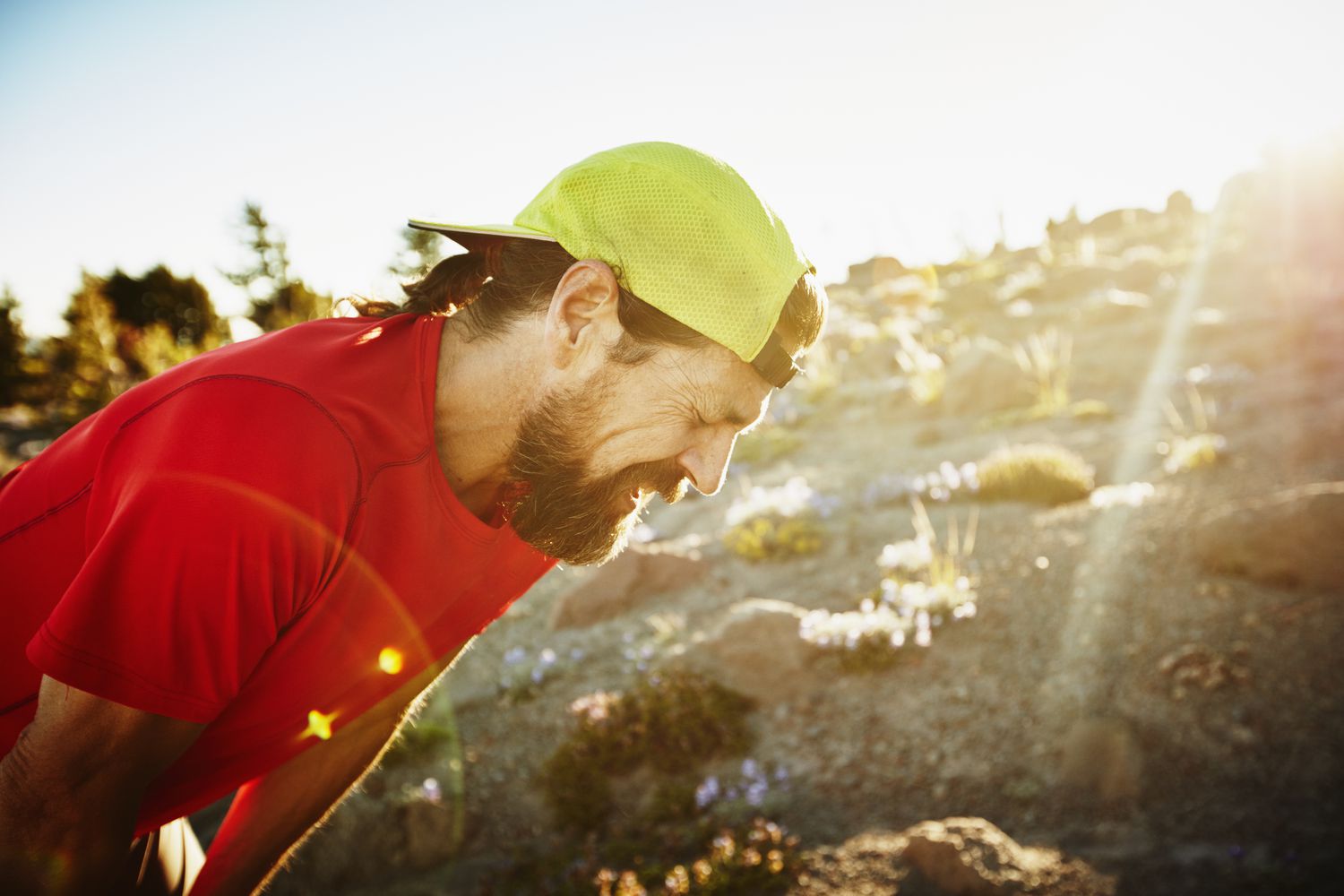Trail runner breathing hard after run on mountain