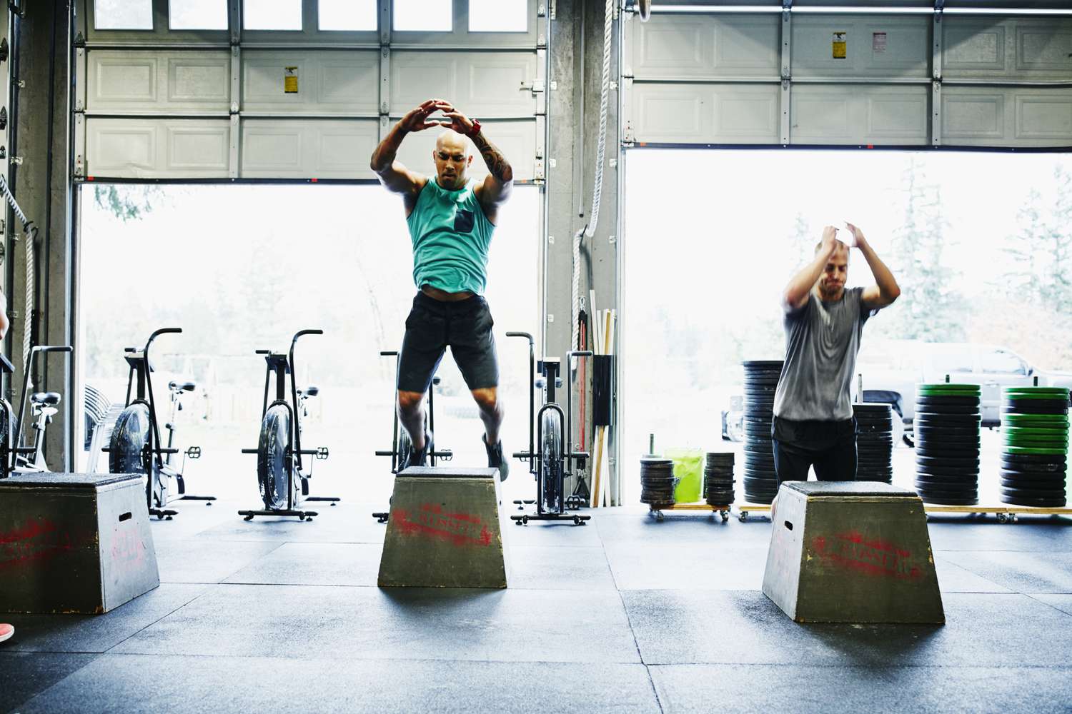 Men doing box jumps in a Crossfit gym