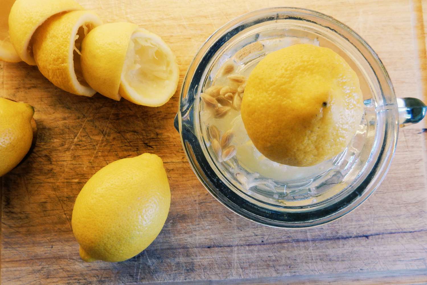 half a lemon being juiced on a citrus juicer