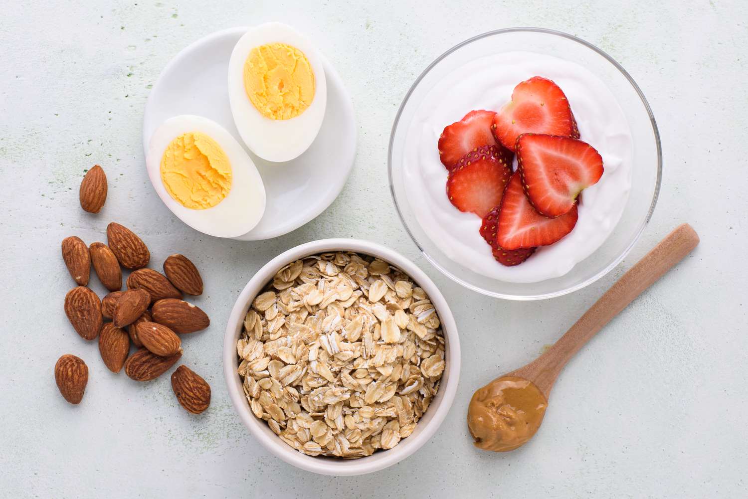 foods to eat before a run including oatmeal, peanut butter, almonds, hard-boiled eggs, and yogurt with fruit