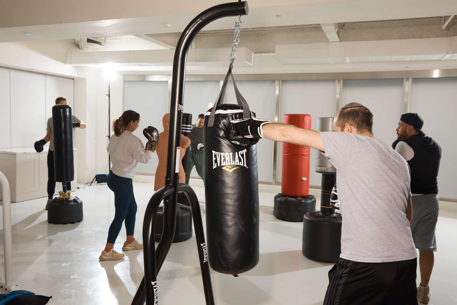 Person punching an Everlast Single Station Heavy Bag Stand with 70-lb. Heavy Bag Kit 