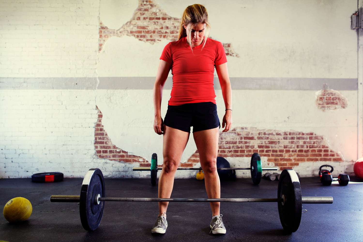 a woman weightlifting in a gym