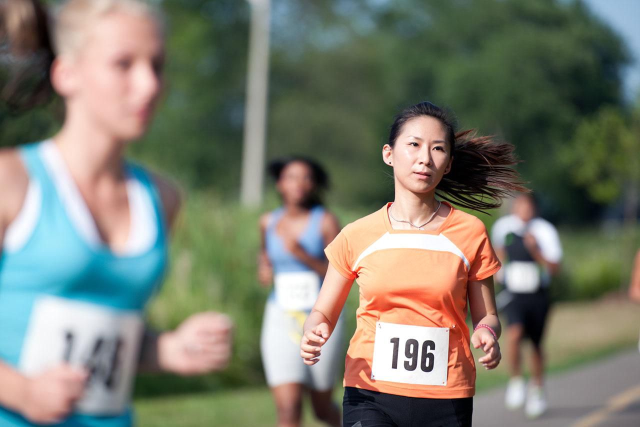A young woman at a cross country running race.