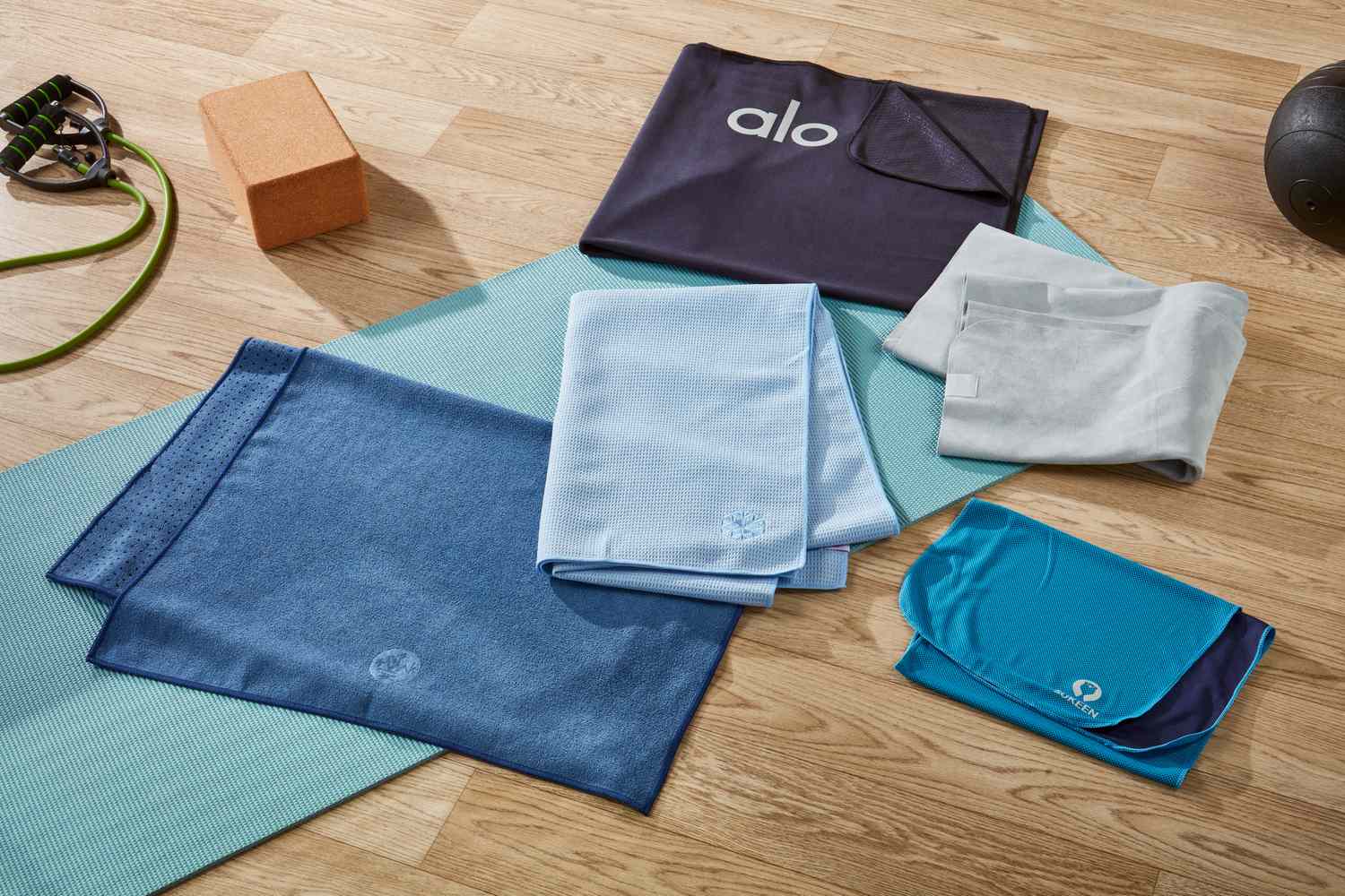 6 yoga towels on floor with yoga accesories