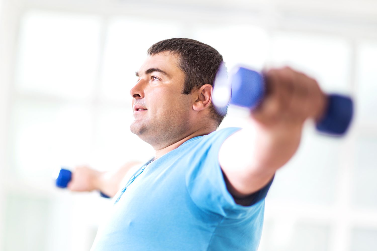 man exercising with dumbbells.