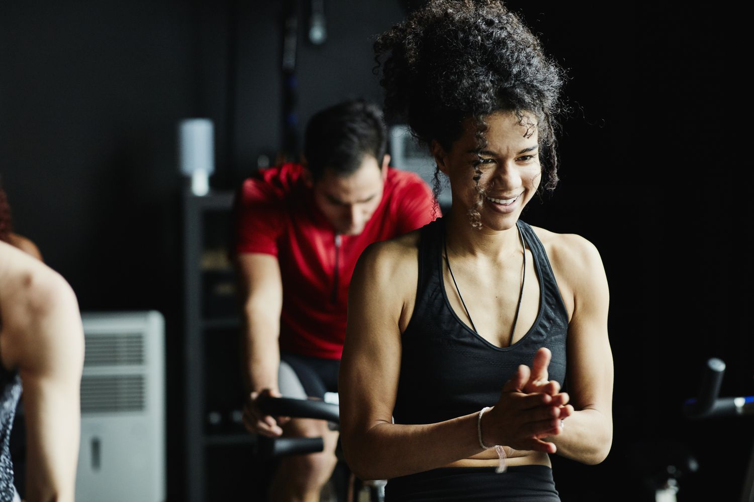 Woman laughing during indoor cycling class in fitness studio