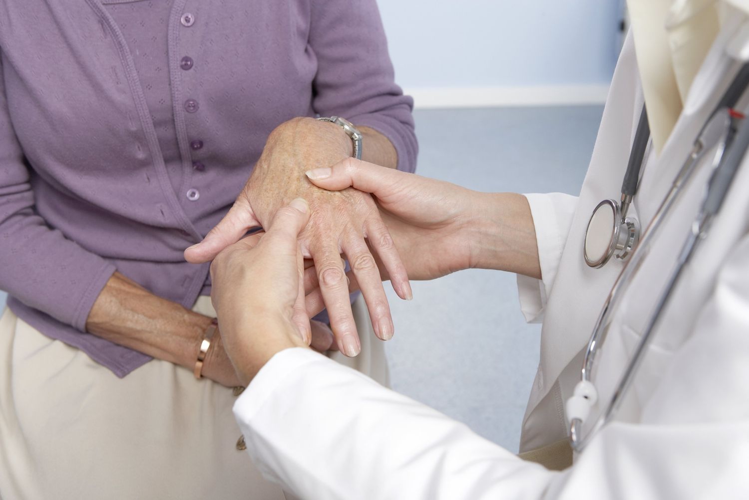 Rheumatoid arthritis, general practitioner examining patient and hand for signs of rheumatoid arthri : Stock Photo CompAdd to Board Caption:Rheumatoid arthritis. General practitioner examining a patient's hand for signs of rheumatoid arthritis. This condition is caused by the immune system attacking the body's own tissues, causing progressive joint and cartilage destruction. As the cartilage is worn away, new bone grows as part of the repair process. This causes stiffness and deformity of the fingers. Treatment is with anti-inflammatory drugs and physiotherapy. Rheumatoid arthritis, general practitioner examining patient and hand for signs of rheumatoid arthritis
