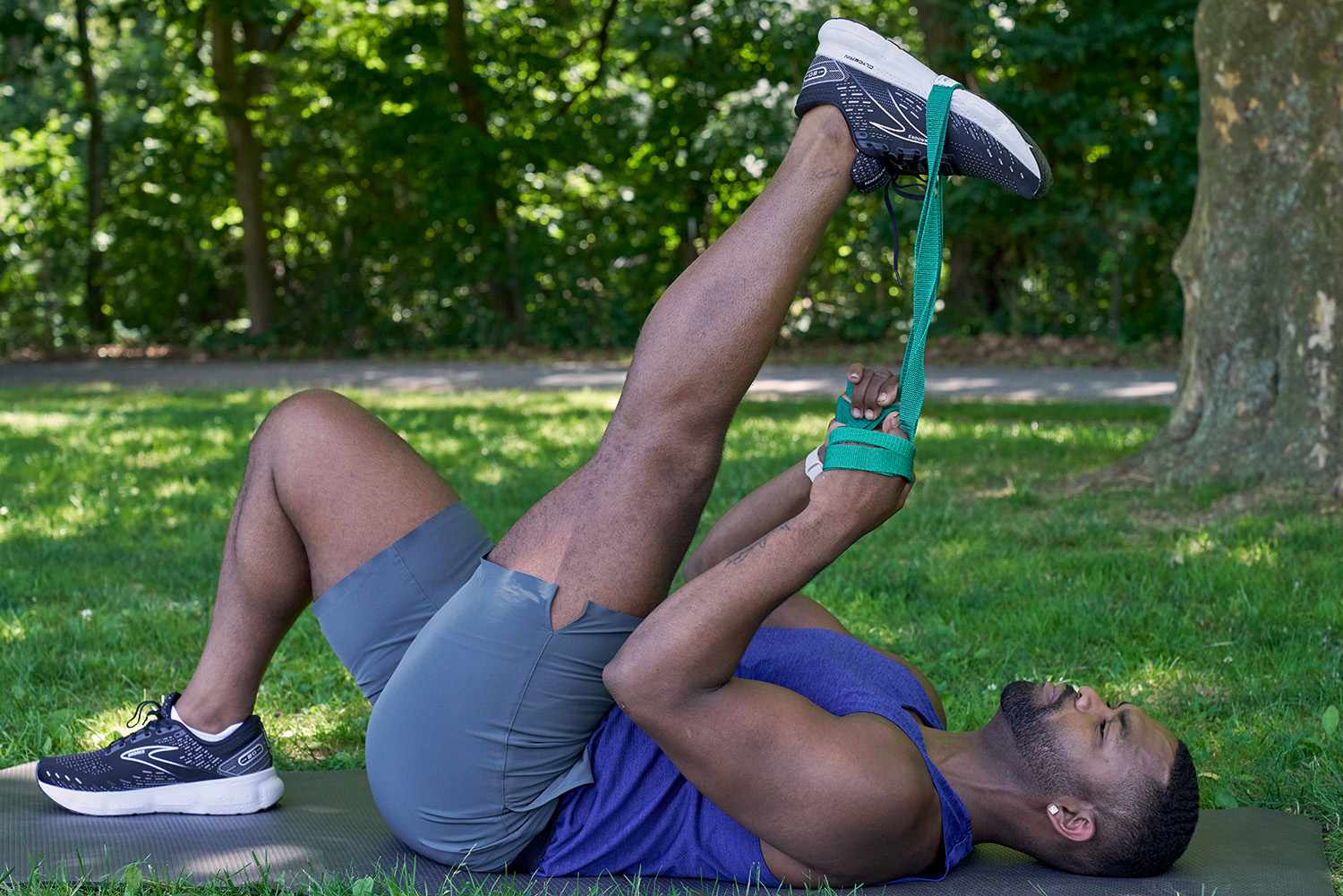 man using a resistance band to stretch leg