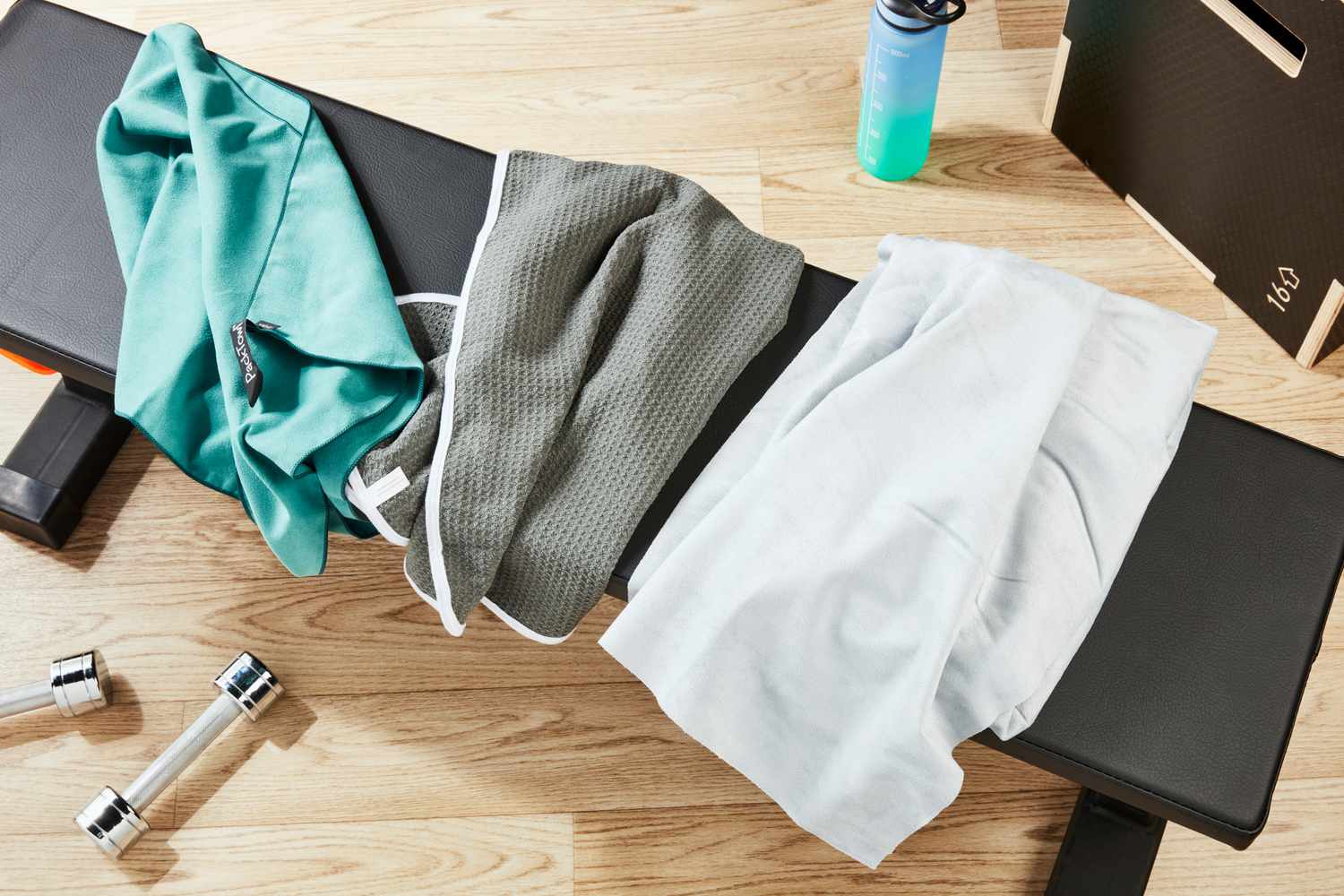 Three gym towels we recommended hanging on workout bench