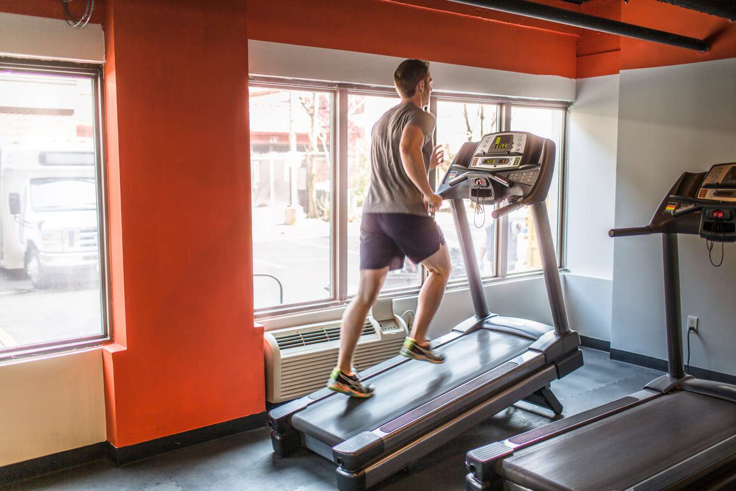 Man running uphill on treadmill