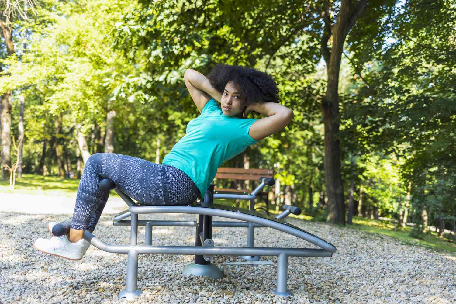 woman doing sit-ups in the park