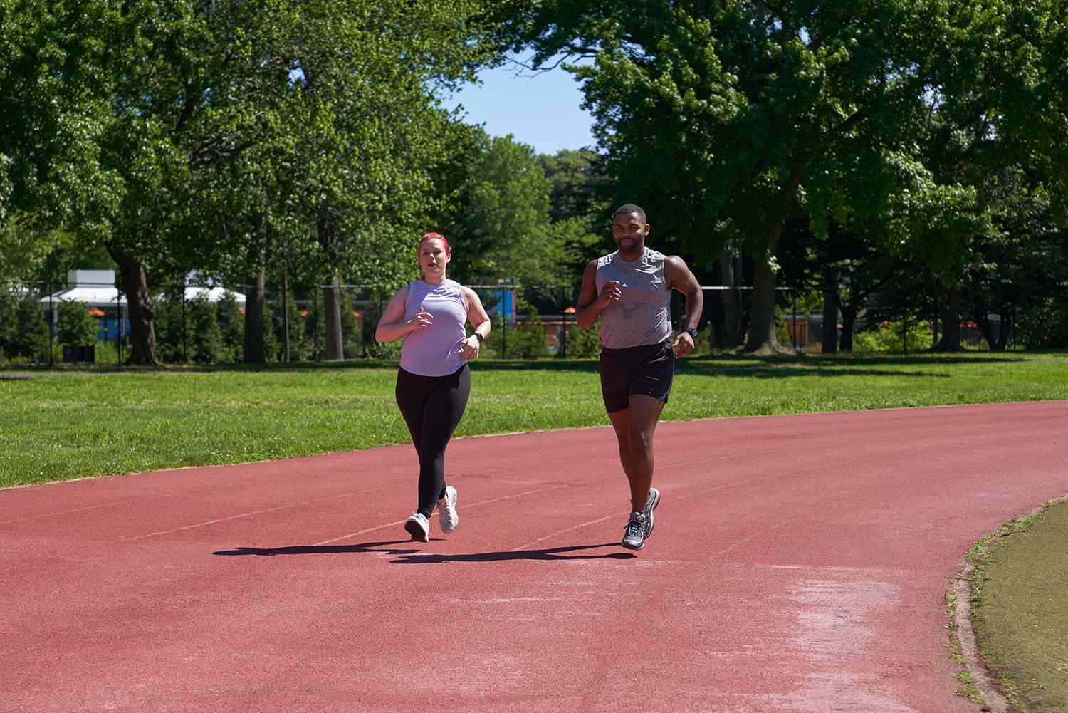 man and woman running on a track
