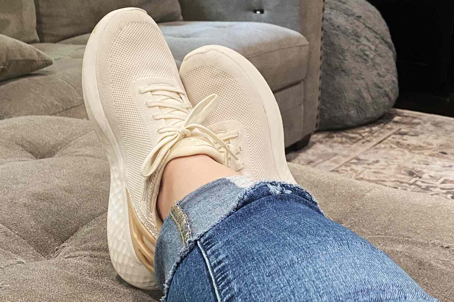 Kizik Women's Athens Sneakers being worn on a couch