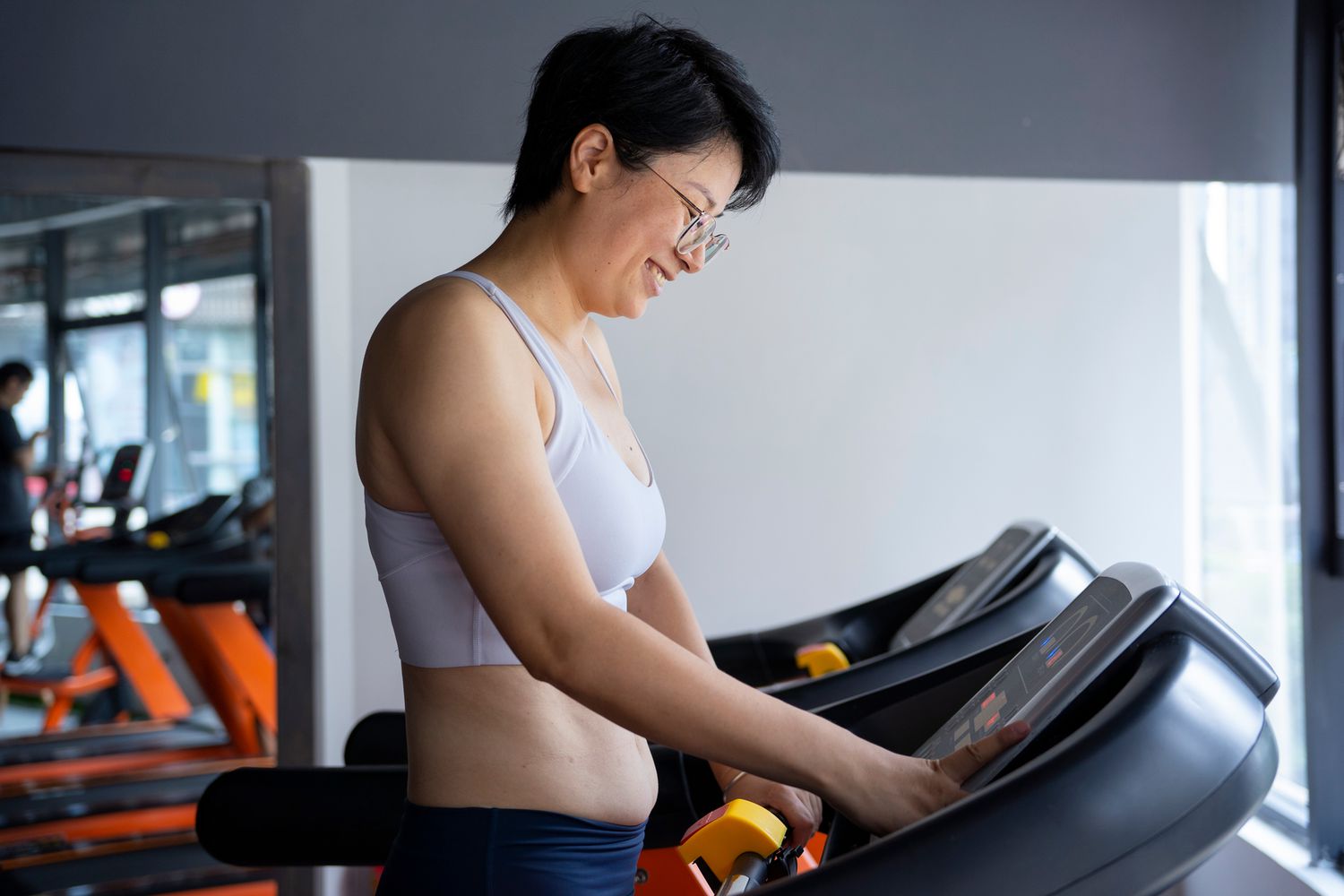 woman setting a treadmill