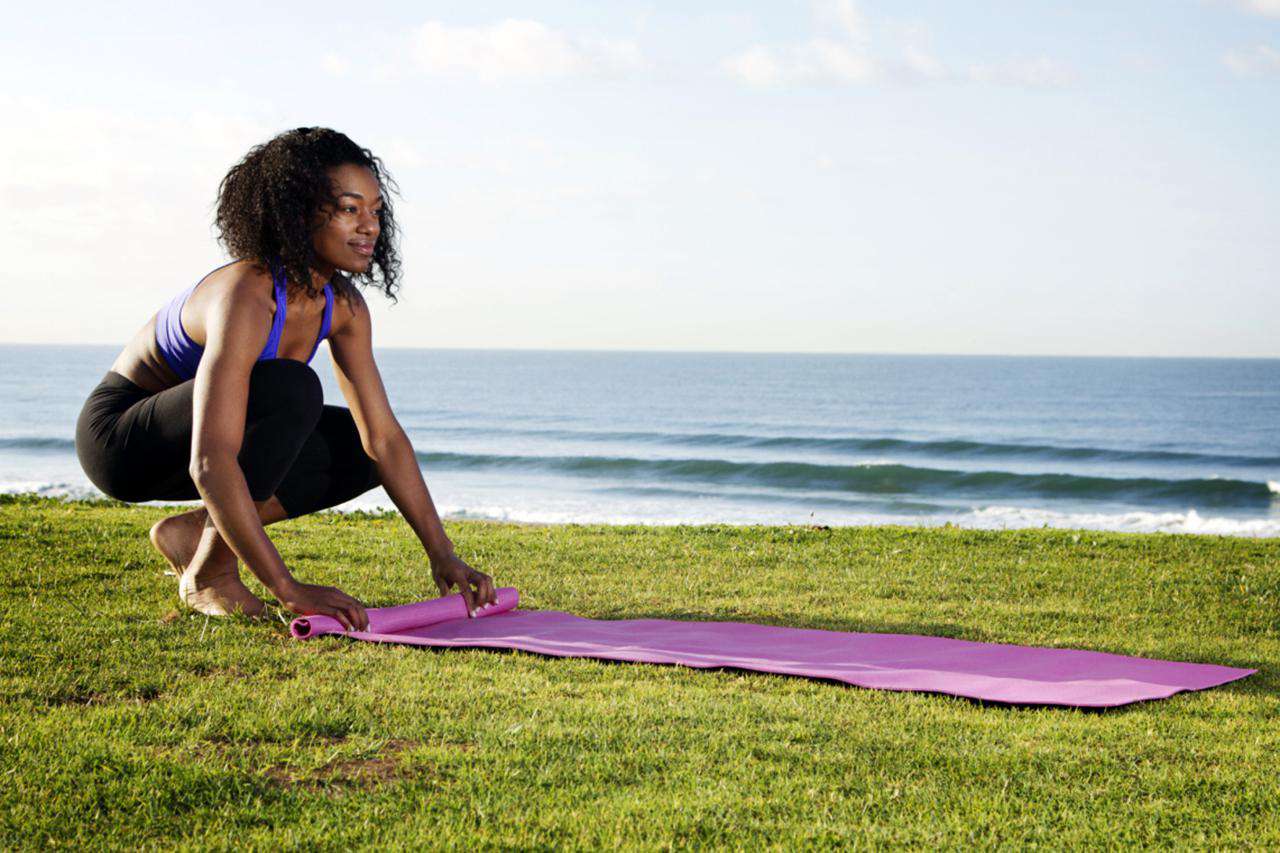 Woman Rolling Up Yoga Mat