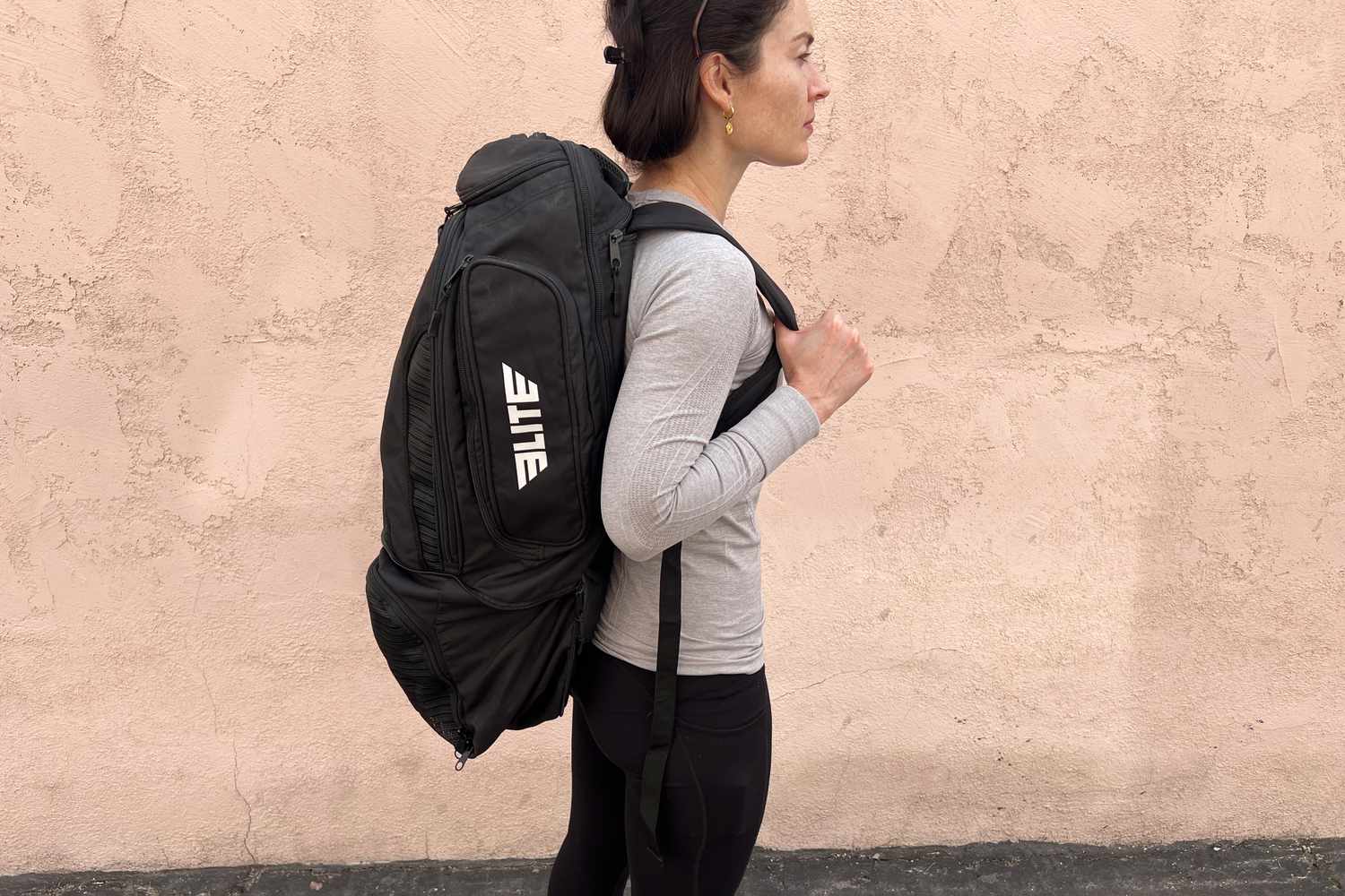 Person wearing the Elite Convertible Gear Gym Bag & Backpack on their back