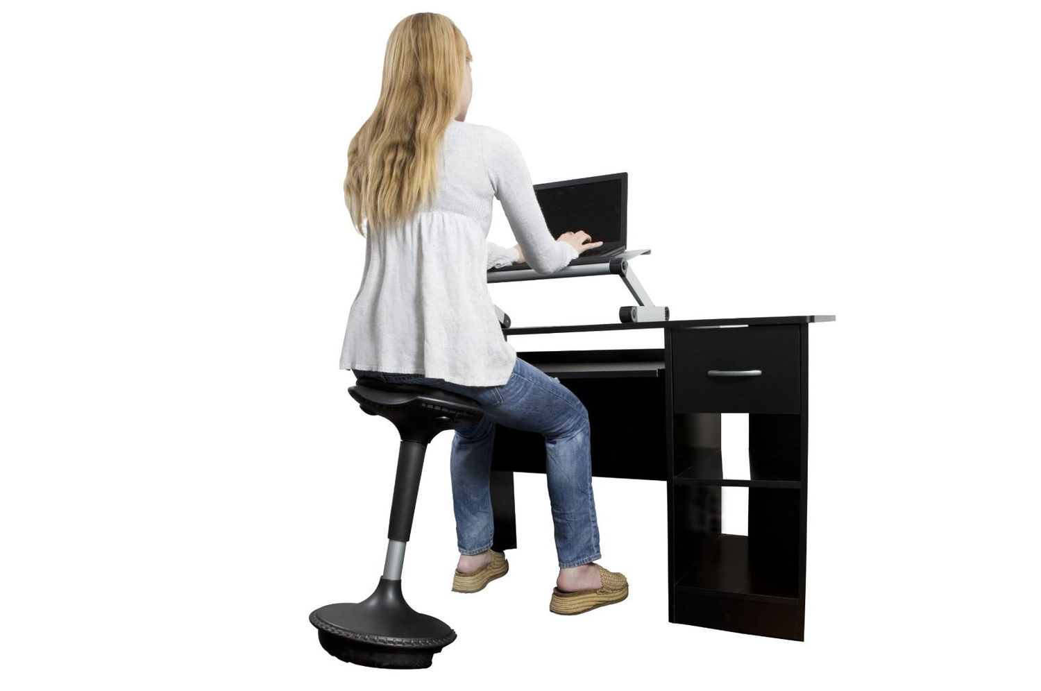 Woman sitting on a wobble stool using a laptop
