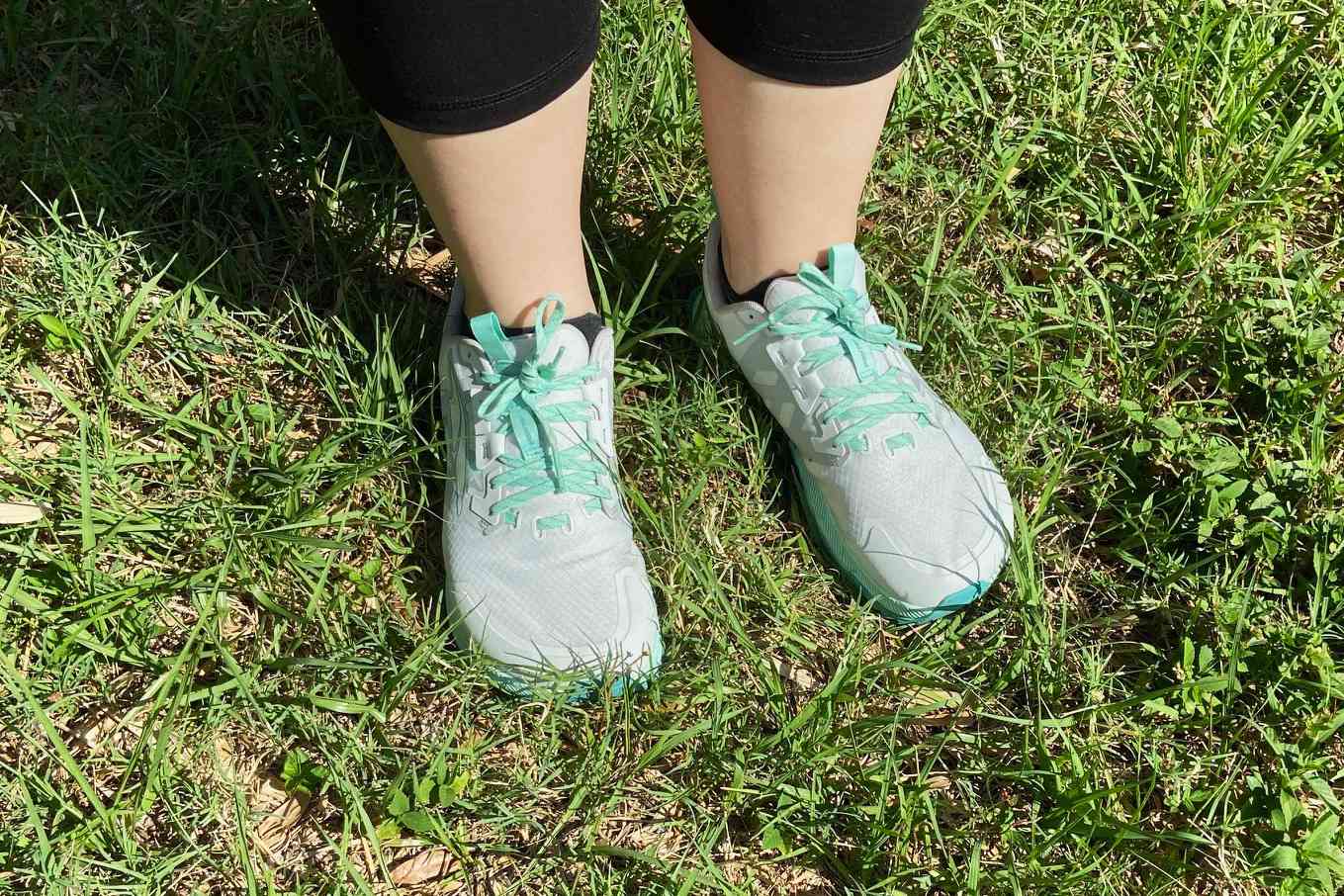Person wearing Altra Women's Lone Peak 7 Trail Running Shoes on grass