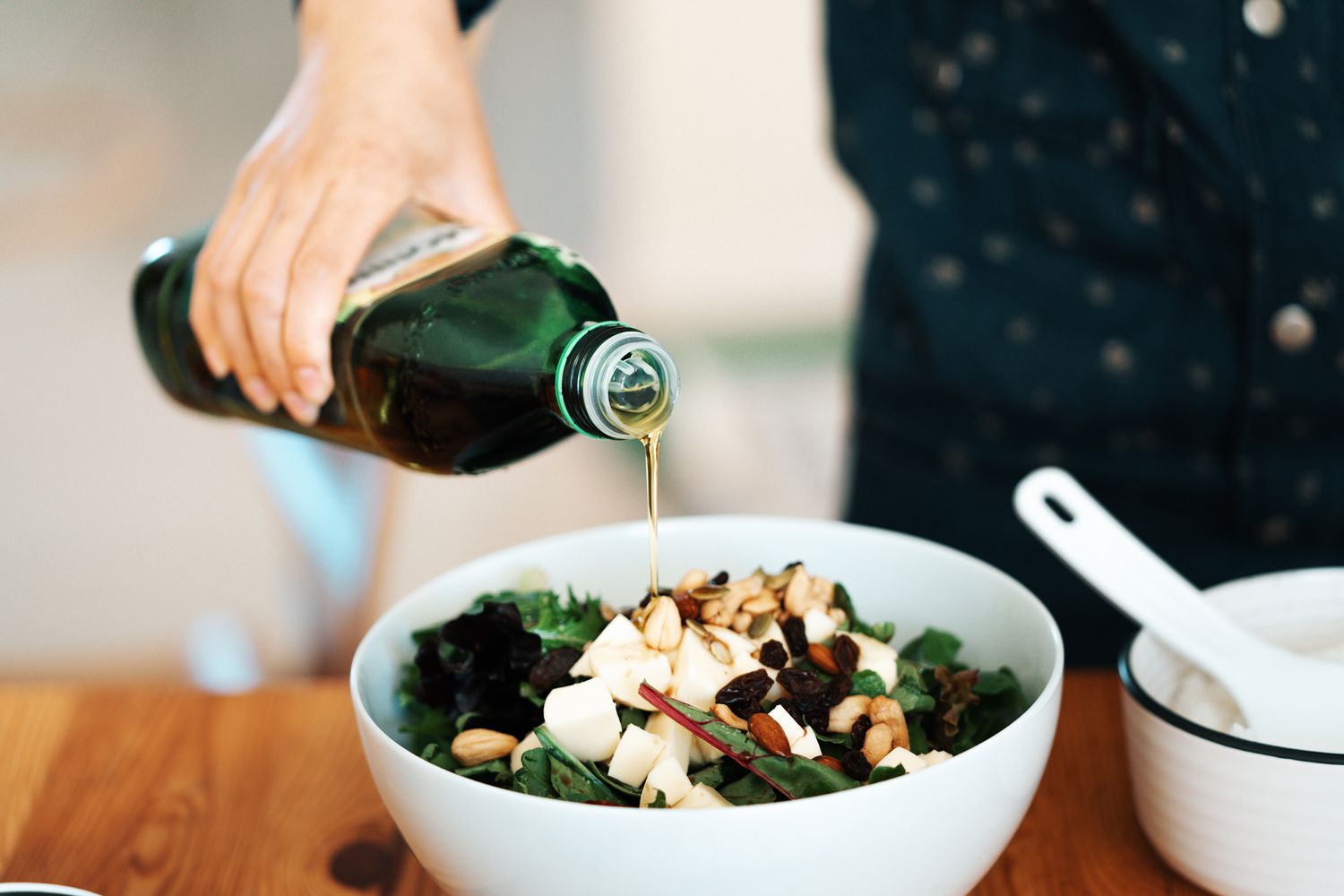 Fresh green salad with olive oil, mozzarella, mixed nuts, and dry fruits