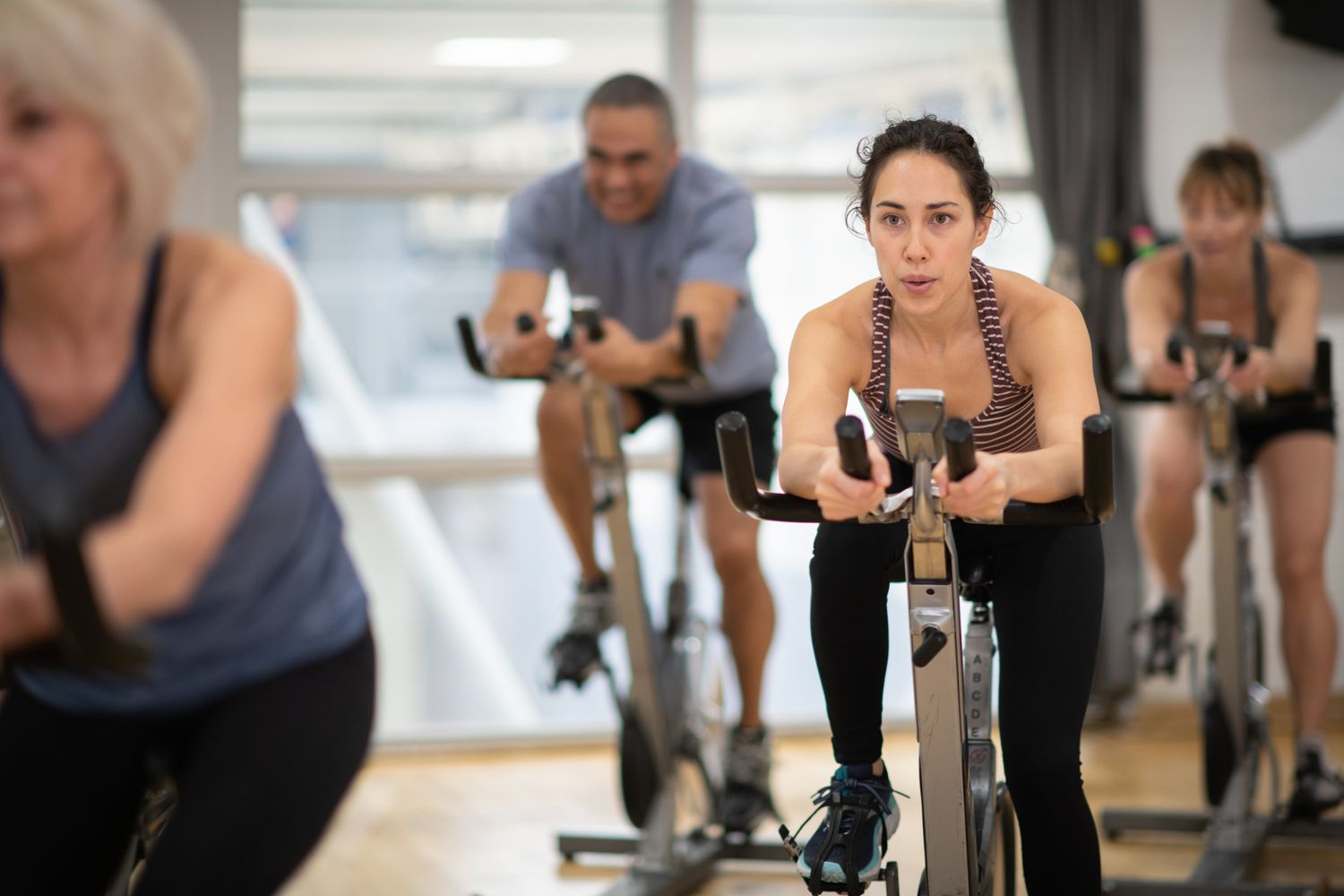 Woman taking an indoor cycling class