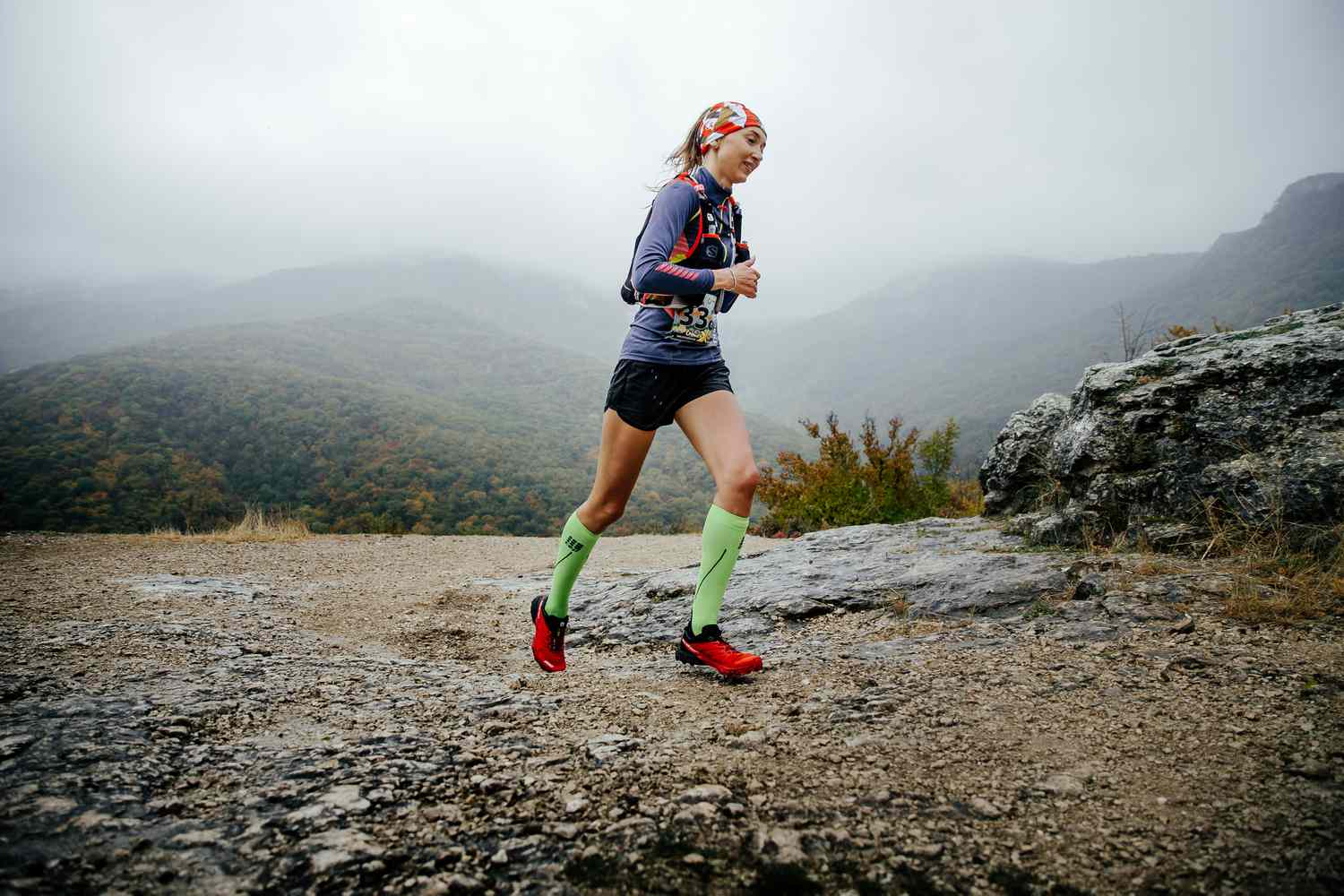 woman trail running with compression socks
