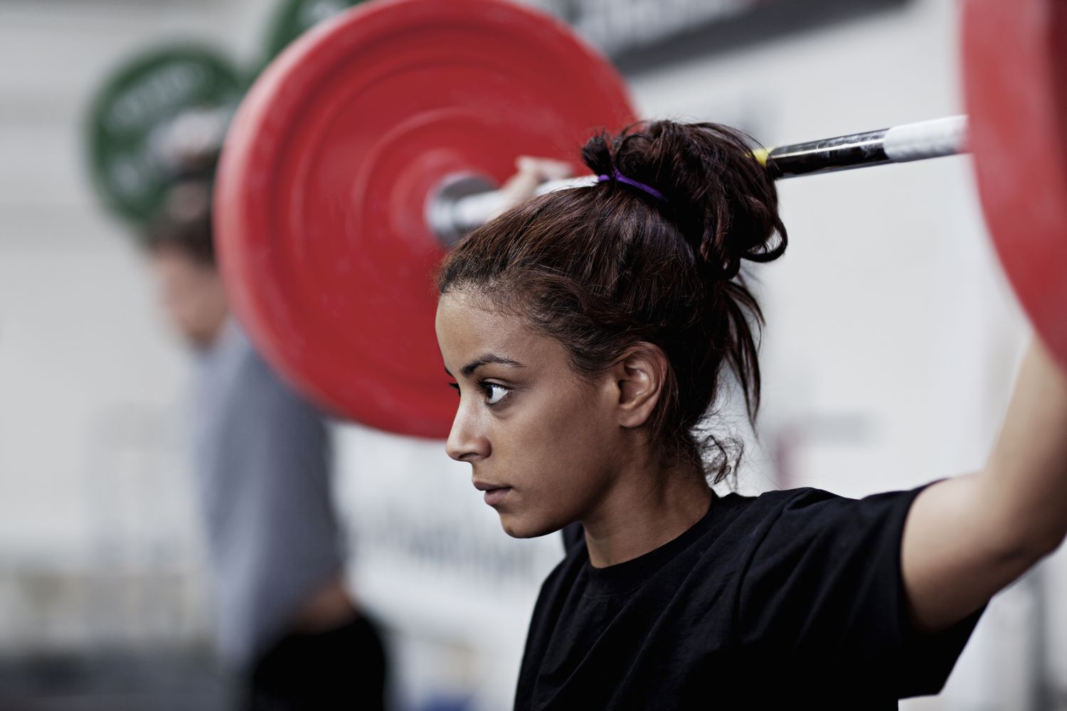 Young woman lifting weight