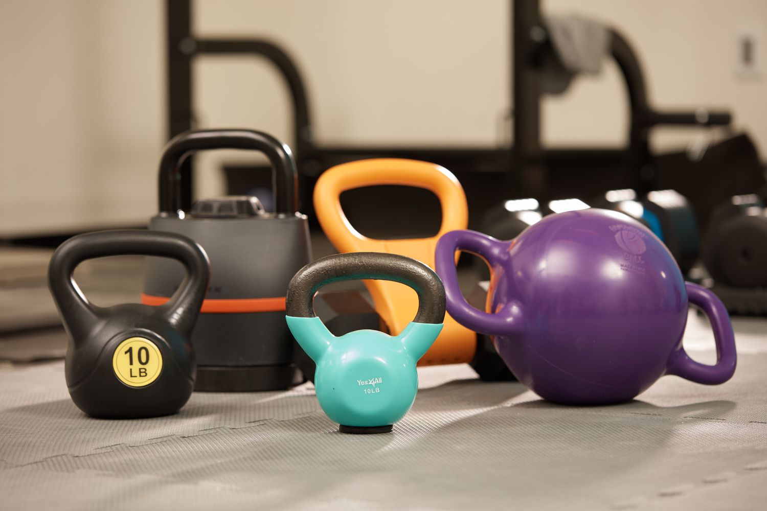 Kettlebells together in a group on a grey floor