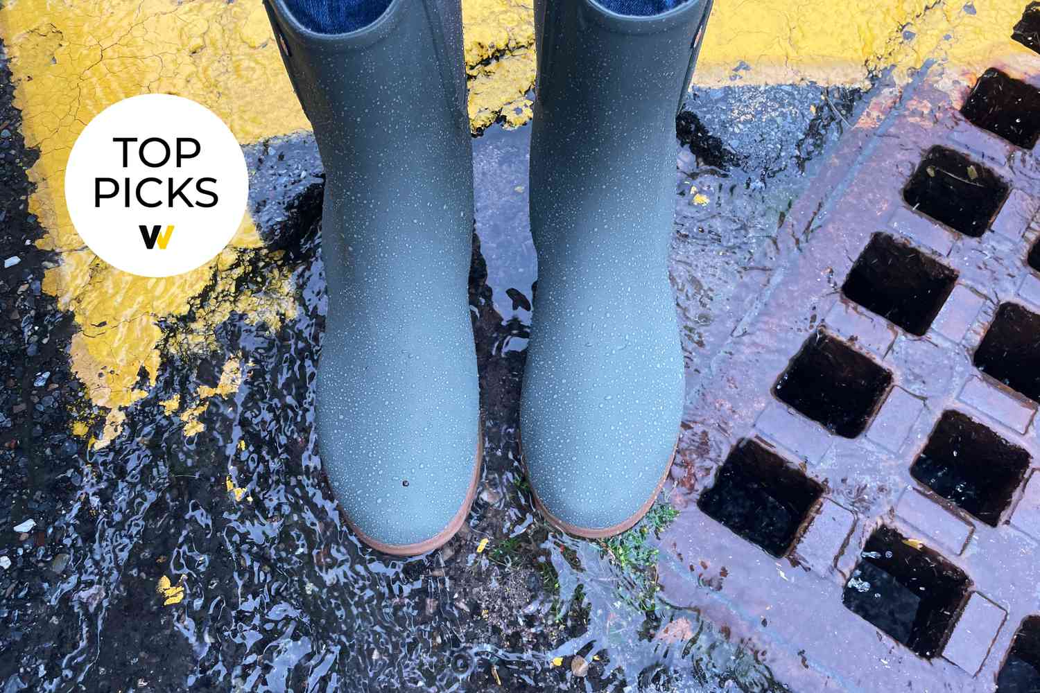 Above angle view of Waterproof Bogs Sweetpea Tall Rain Boots standing on wet ground