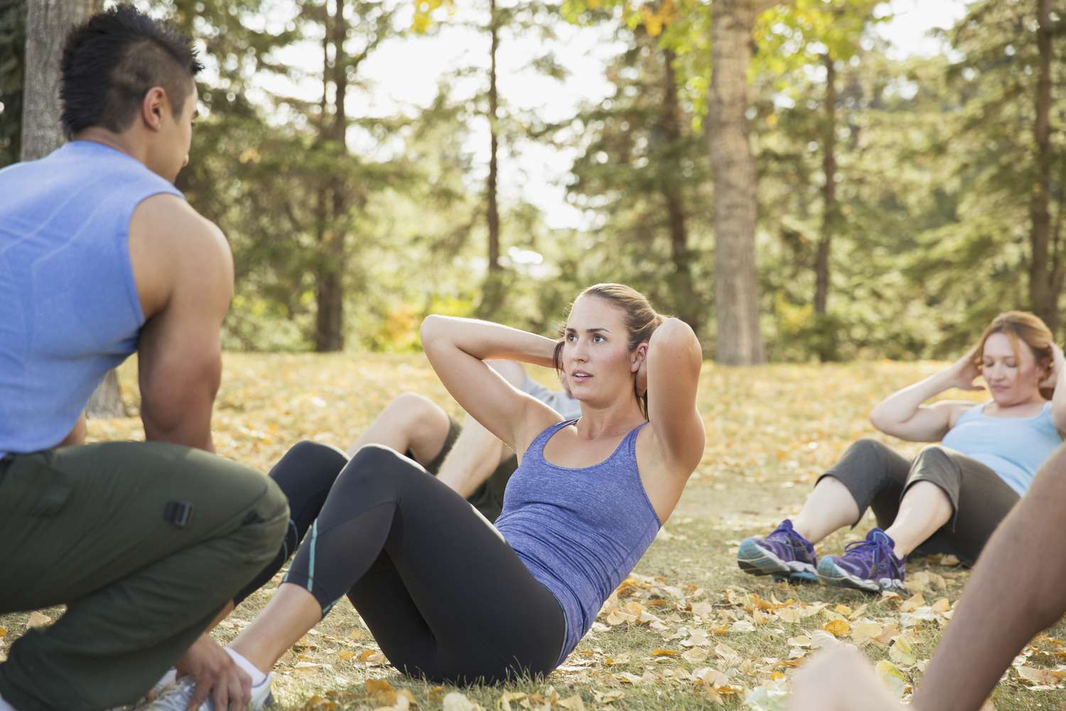 women with personal trainer doing outdoor boot camp workout