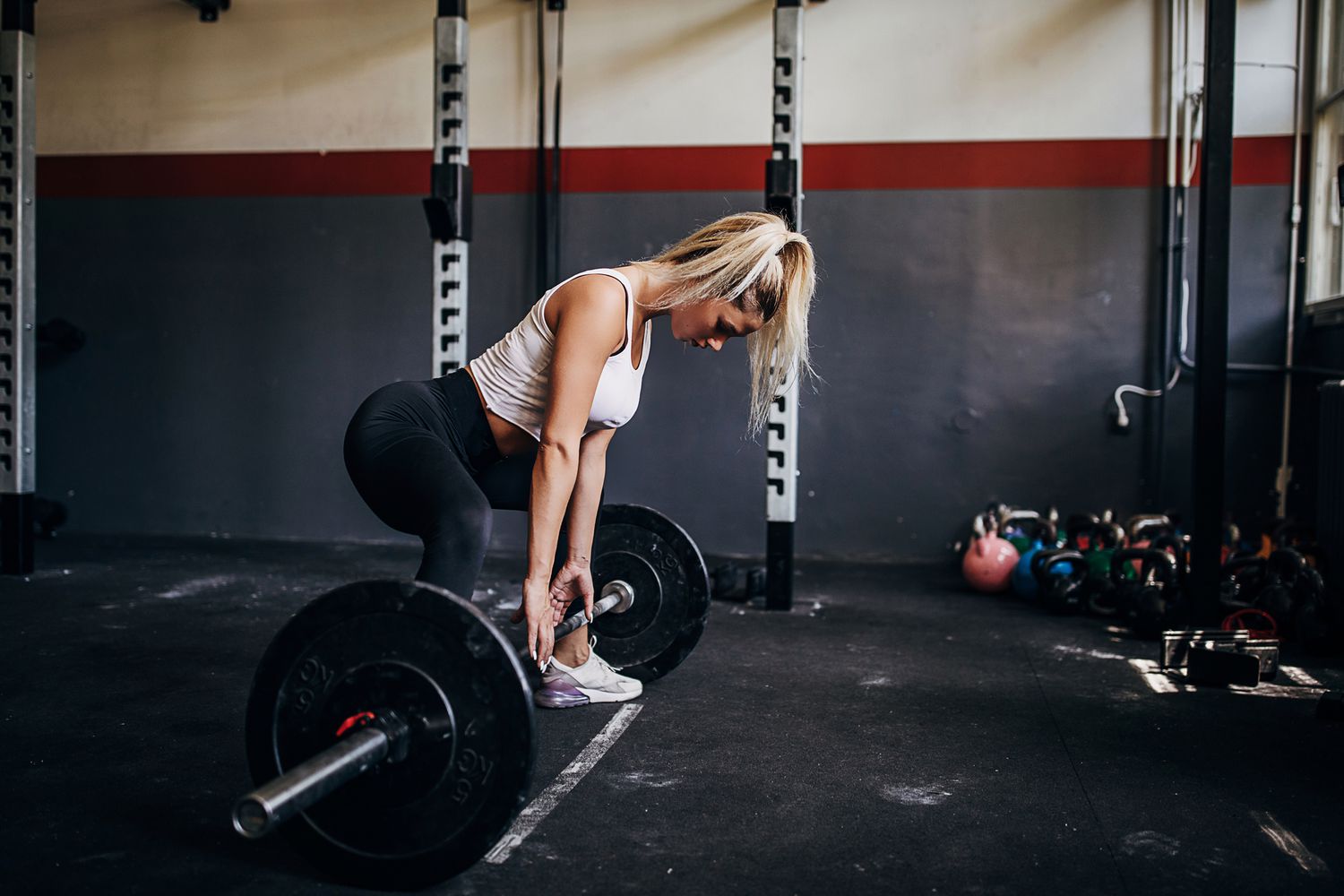 woman setting up for sumo deadlift
