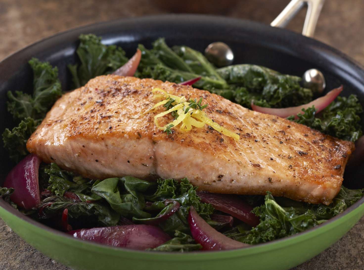 salmon with kale in pan