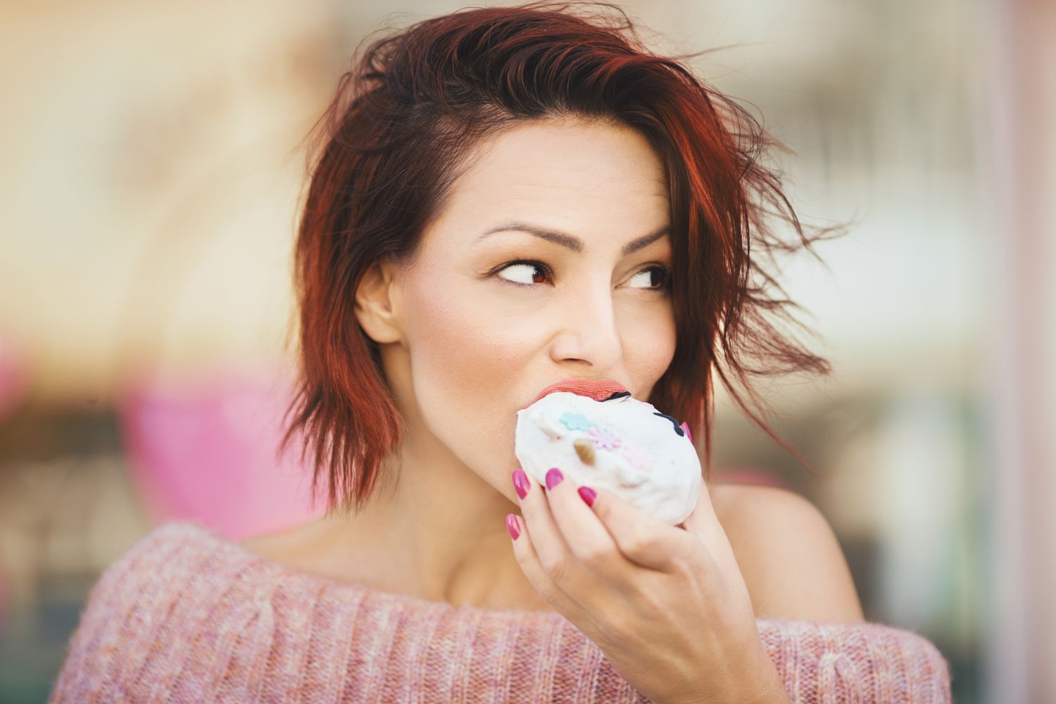Girl with short hair eating a donut